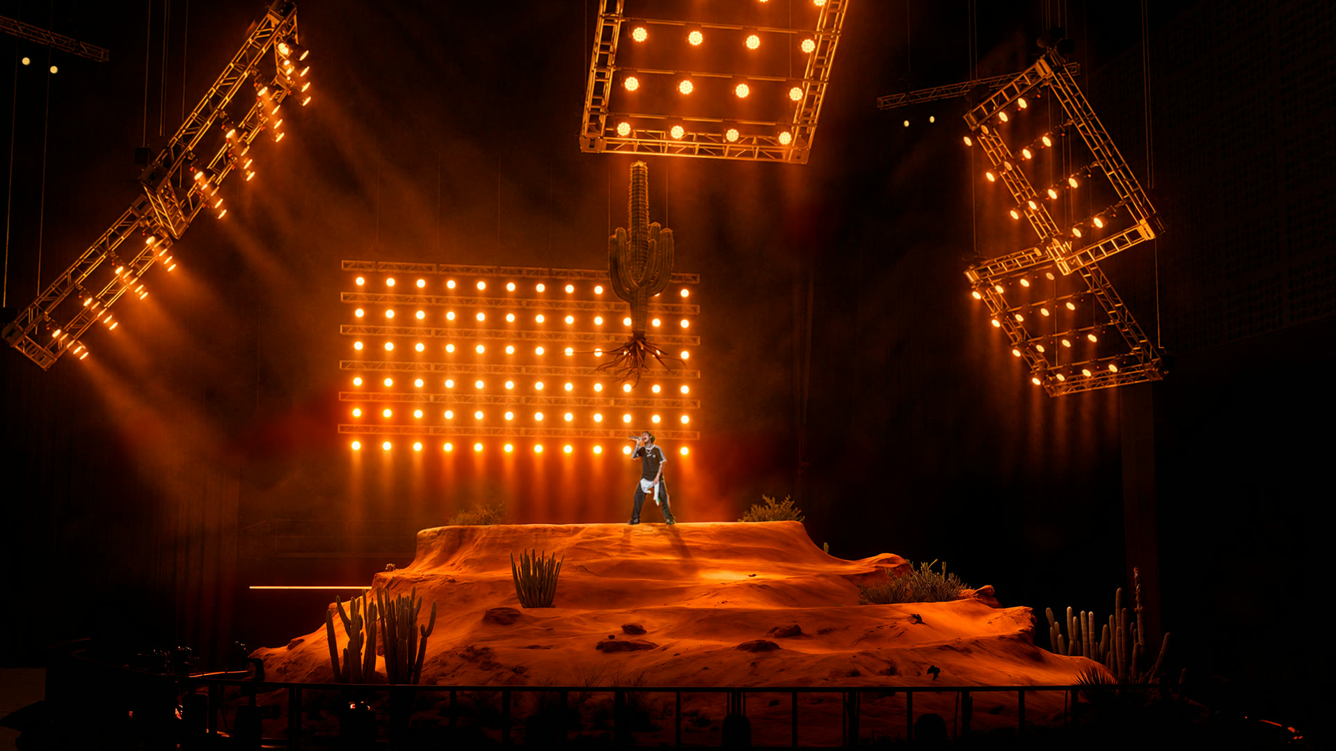 Render: amber-lit general view of the scenic dune with the performer and lighting rigs