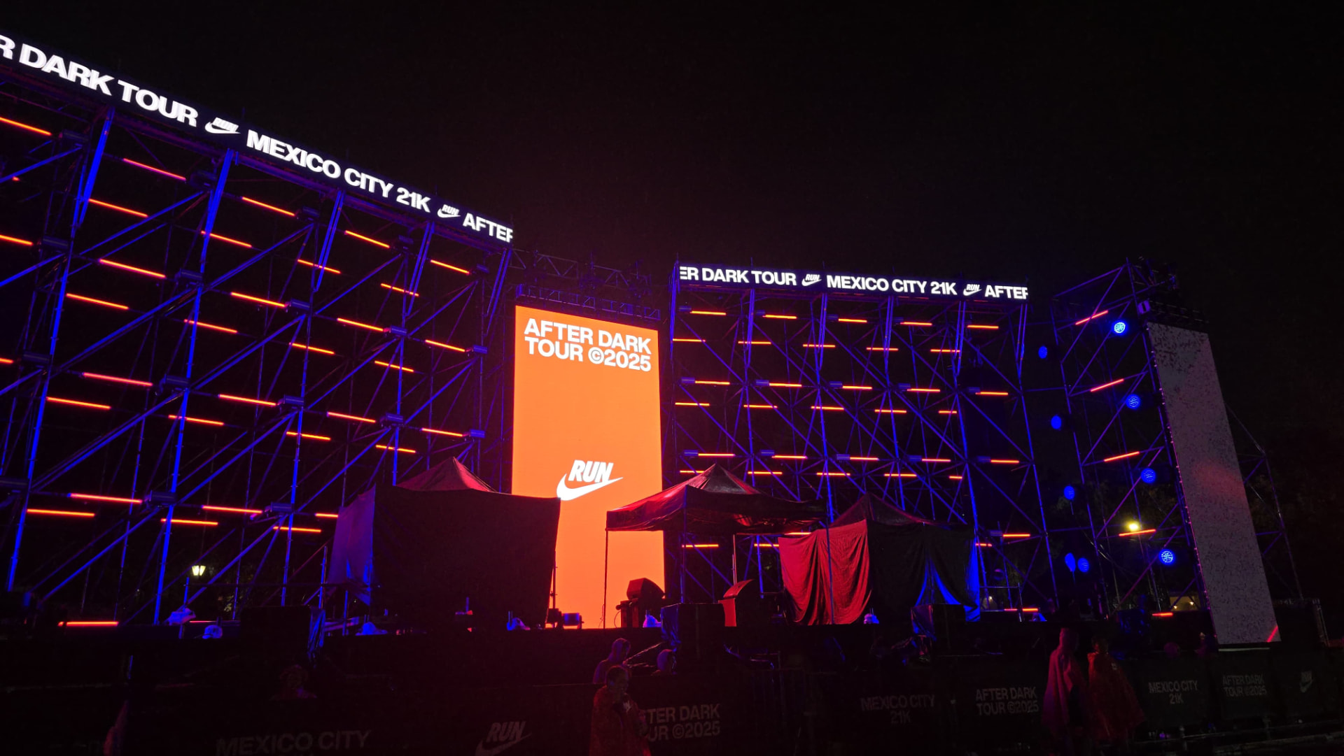 Built Nike After Dark Tour stage at night with red central screen
