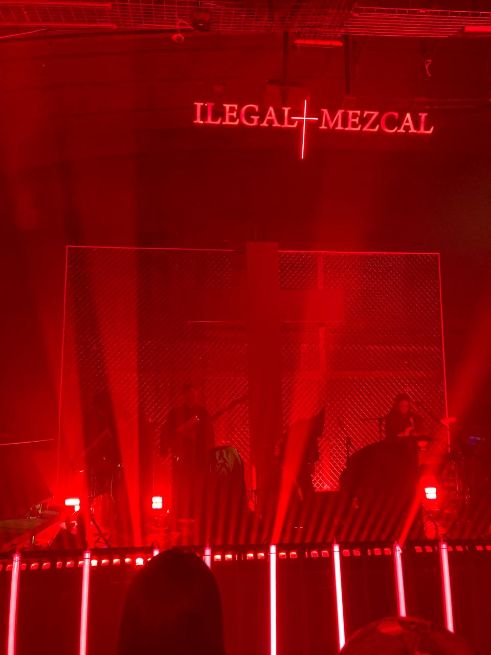 Built Fiesta Ilegal stage with red illumination, metal mesh and the illuminated cross.